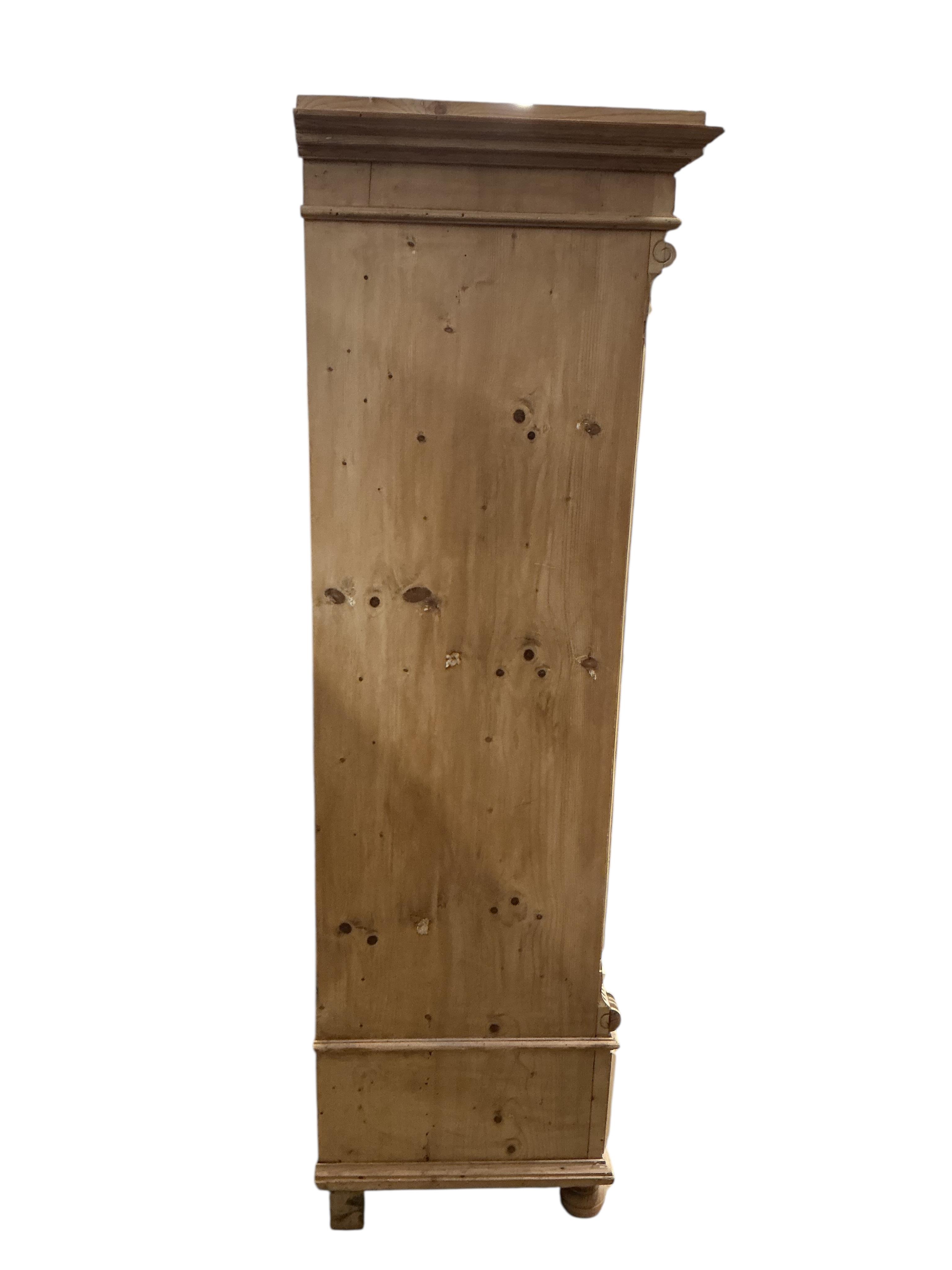 A 19th century East European glazed pine armoire, width 105cm, depth 56cm, height 182cm